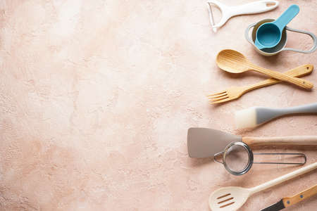 A set of knives. Various kitchen utensils on a gray table background, flat lay, with place for text.の写真素材