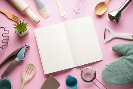 Kitchen utensils on a pink background with space for text. Flat lay.の写真素材