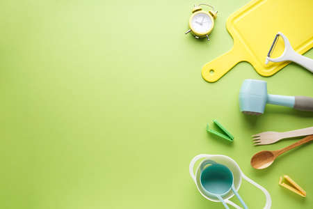 Kitchen utensils on a light green background with space for text. Flat lay.の写真素材