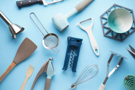Various kitchen utensils on a blue background. Top view.の写真素材