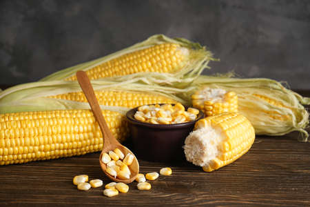 Fresh corn on the cob of corn on a wooden background
