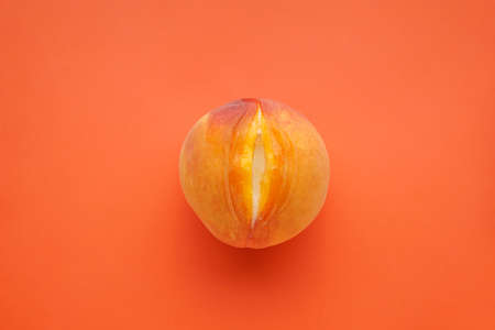 Juicy peach and condensed milk on a orange background, top view. Sex conceptの写真素材