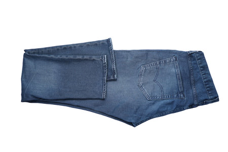 Folded blue mens denim trousers isolated on white background.の写真素材