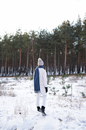 Fashion young woman in winter forest, verticallyの写真素材