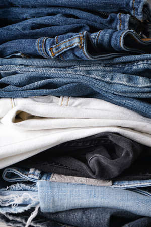 Folded jeans on gray background. Close-up. Vertically.の写真素材