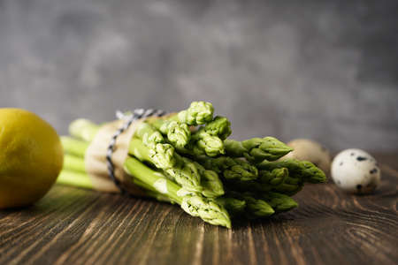 Fresh asparagus on wooden background, space for text. Close-up.
