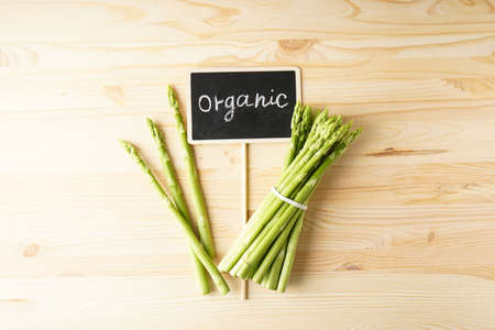 Fresh green asparagus on wooden background. Top view.の写真素材