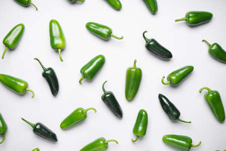 Green chili pepper. Group of jalapeno peppers on a white background, flat lay.の写真素材
