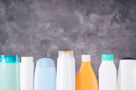 Composition with plastic bottles of body care and beauty products on a gray background. Place for text.の写真素材