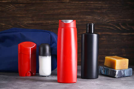 Bottle of shampoo, deodorant, soap and body care on a wooden and gray background.の写真素材