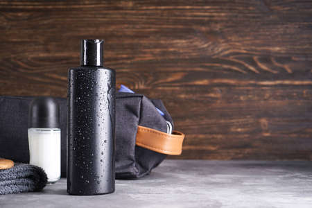 Bottle of shampoo and deodorant on a wooden background. Space for text.の写真素材