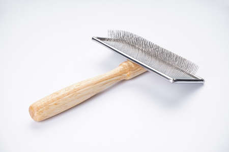 Comb for dogs on a white background. Brush for grooming wool, close-up.の写真素材