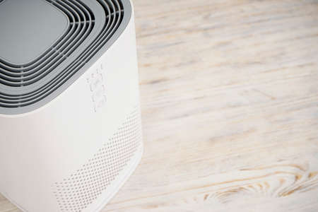 Modern air purifier on a wooden background top view, place for text.の写真素材