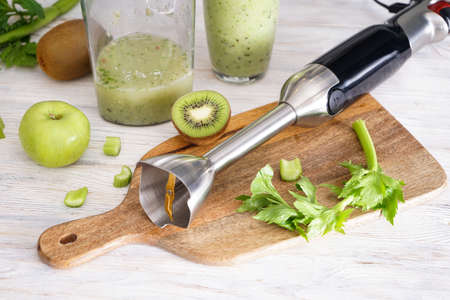 Hand blender for mixing organic raw fresh fruits for making vitamin diet smoothie, healthy food. Close-up.の写真素材