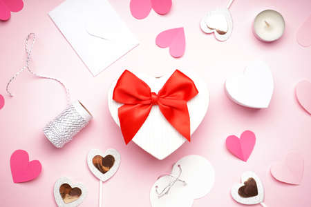 Gift boxes for Valentine's Day and confetti on pink background, flat layの写真素材