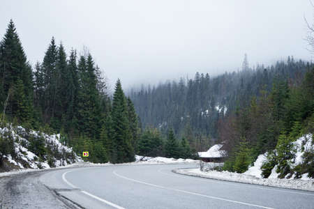 road trip concept. Empty country road in winter. Winter trip. Trees and roadside in the snow.の写真素材