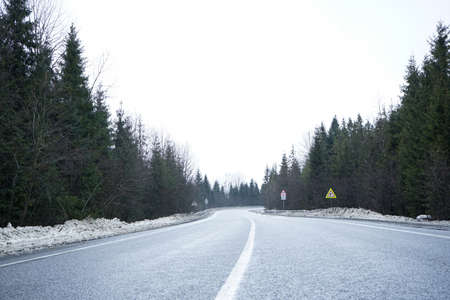 road trip concept. Empty country road in winter, roadside in the snow. Winter trip.の写真素材