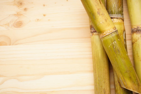 Close-up sugarcane on wooden background, with space for text. flat lay.の写真素材