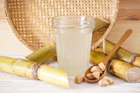 Fresh cane juice and granulated brown sugar on a light background.の写真素材