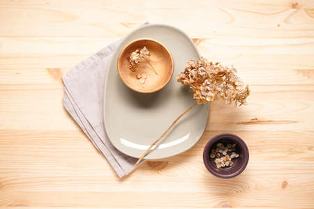 Hydrangea, dried flowers and plates on a wooden background. top view. Pastel, natural colors. vintage style.の写真素材