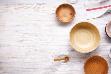 Modern wooden and glass crockery, trendy tableware with space for text. Dishes for serving and eating meals on a wooden background, top view.の写真素材