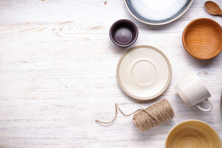 Modern ceramic and wooden crockery, trendy tableware with space for text. Dishes for serving and eating meals, top view.の写真素材