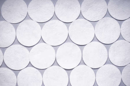 spa concept. Cotton pads on a pink background. top view.