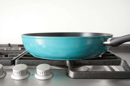 New blue frying pan on the gas stove. close-up.の写真素材