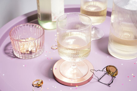 Champagne in glasses and a bottle on a table on a gray background, close-up.の写真素材