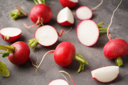 Fresh red radish slice with leaves on gray background. close-up.の写真素材