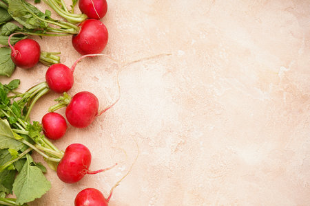 Red radishes on a beige background, space for text, top view.の写真素材