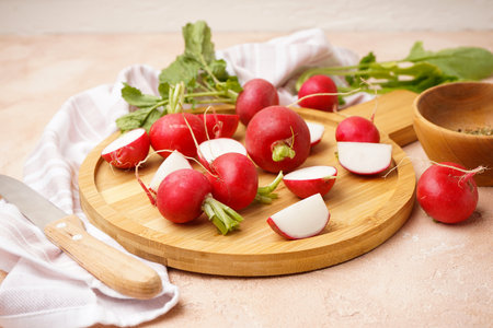 Fresh red radish on cutting board on a beige background.の写真素材