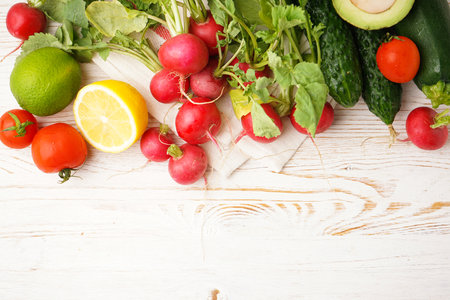Radish and other spring vegetables on a wooden background, space for text. top view.の写真素材