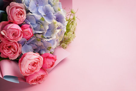 Bouquet of peony roses with hydrangea on a pink background, space for text. flat lay.の写真素材