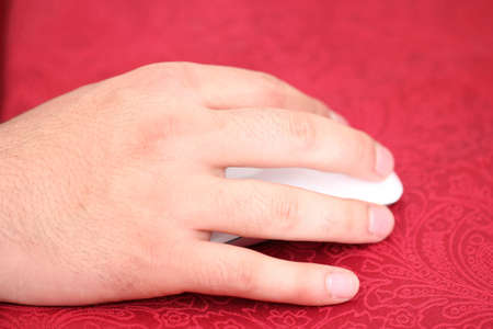 Hand working on a mouseの写真素材