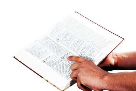 Praying hand hold an open bibleの写真素材