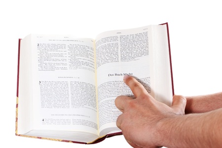 Praying hand hold an open bibleの写真素材