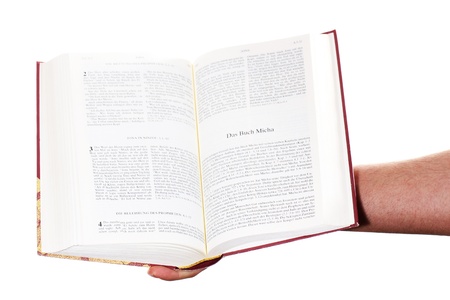 Praying hand hold an open bibleの写真素材