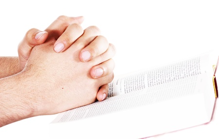 Praying hand hold an open bibleの写真素材