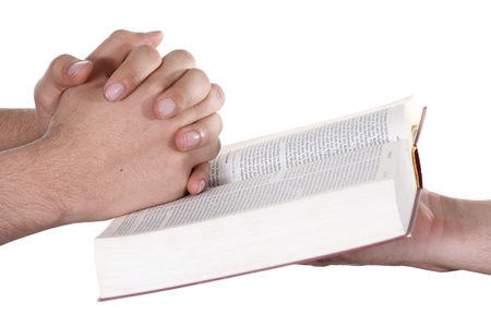 Praying hand hold an open bibleの写真素材