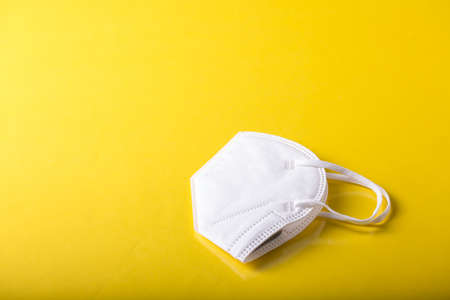 close up of a Yellow isolated face mask with yellow backgroundの写真素材