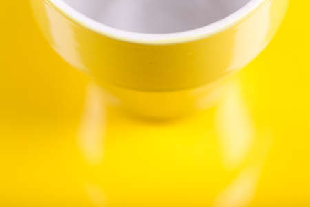 Yellow background with a white and yellow mugの写真素材