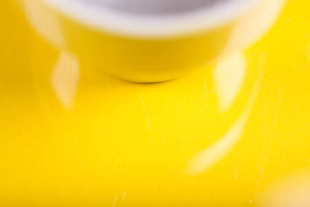 Yellow background with a white and yellow mugの写真素材