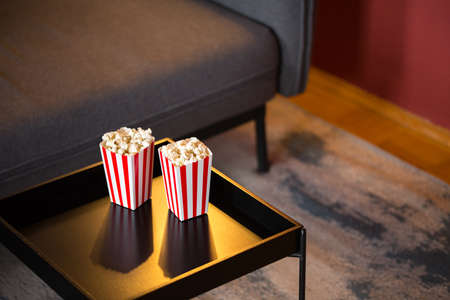 Home Cinema. Watching tv series with 2 boxes of pop corn. Living Room, sofa.の写真素材