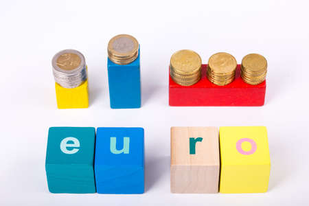 pile of paper and metal euro banknotes and coins on a white background with lettering as part of the...