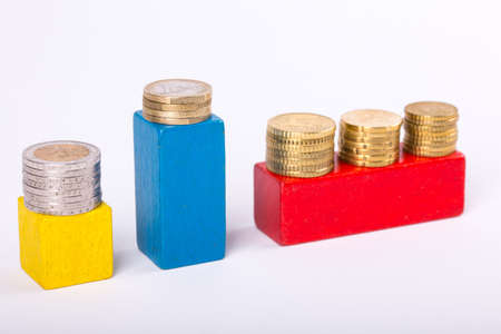 pile of paper and metal euro banknotes and coins on a white background as part of the united country's payment system. Â© Michele Agostinis / Visualbrand Photographyの写真素材