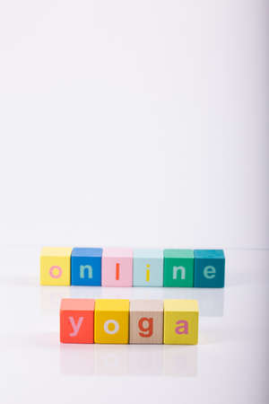 yoga mat with laptop computer ready for an online class or classes with lettering yoga online. Â© Michele Agostinis / Visualbrand Photographyの写真素材