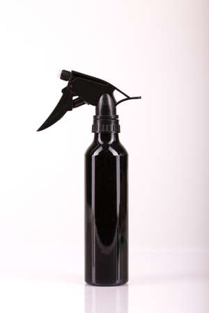 Black hair spray bottle with white background: equipment for free home haircutの写真素材