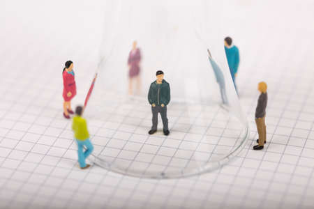 Social distancing, people keeping distance to protect COVID-19 coronavirus outbreak spreading concept, miniature keep distance each other using glass.の写真素材