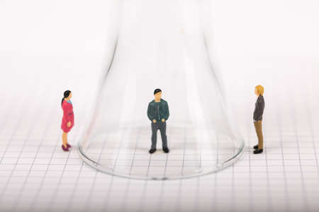Social distancing, people keeping distance to protect COVID-19 coronavirus outbreak spreading concept, miniature keep distance each other using glass.の写真素材